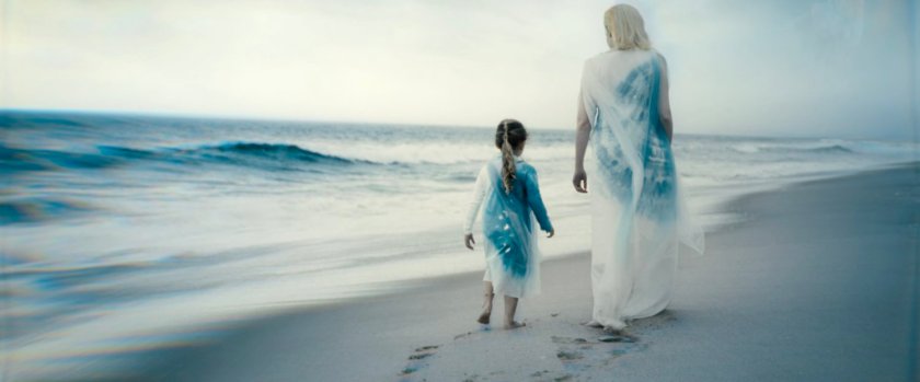 Flashback of Shalla-Bal on Zenn La with her daughter, walking on the beach.