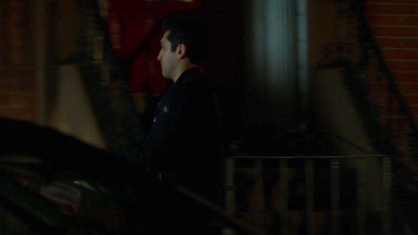 Rafi walking along a sidewalk at night.