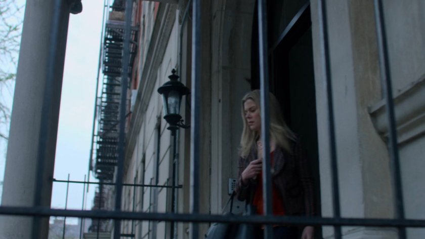 Trish exiting the front of the Alias Investigation building.