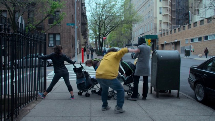 The Whizzer being blocked by moms and baby carriages on a sidewalk in front of the Alias Investigation building.