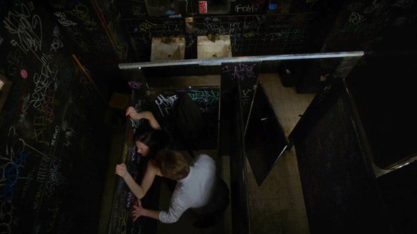 Jessica and a man in a stall at Rudy's Bar.