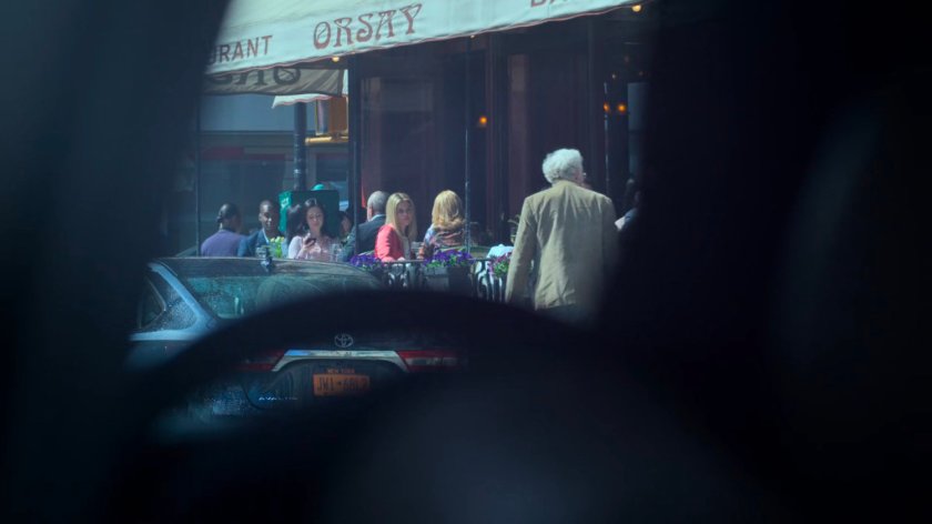 Dorothy and Trish on the outdoor patio at Orsay as seen from a car across the street.