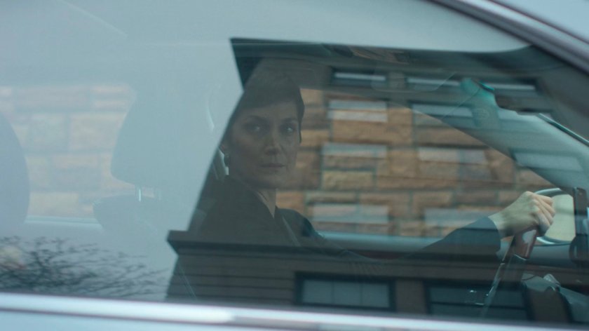 Jeri looking out her passenger side window at an intersection.