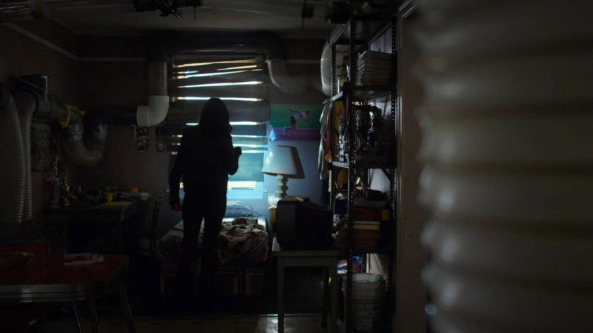 Jessica searching Robert Coleman's apartment.