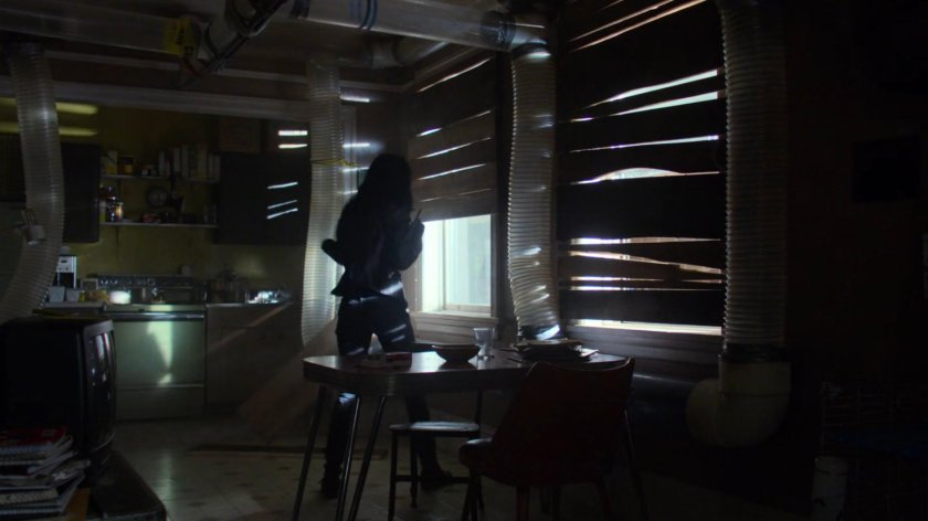 Jessica searching Robert Coleman's apartment.