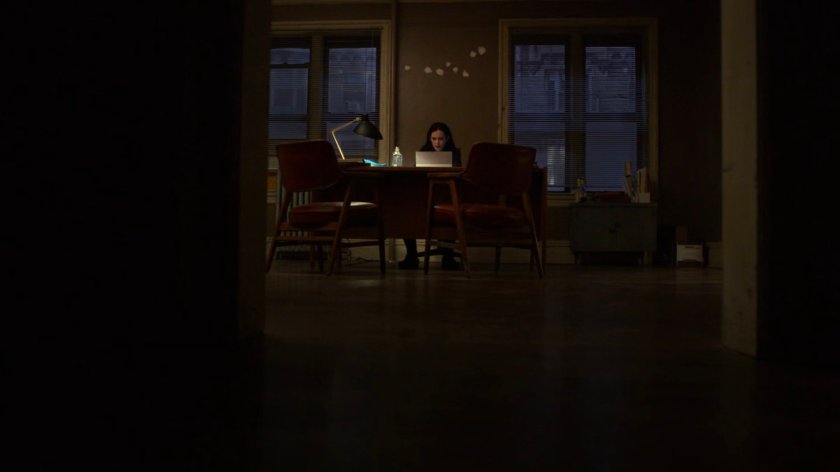 Jessica working at her desk in her office.