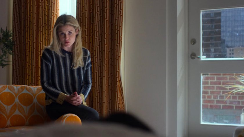 Trish sitting in her apartment.