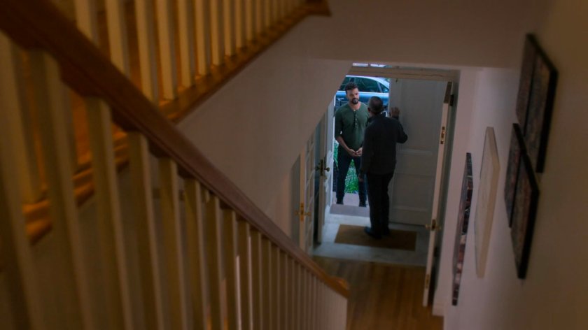 Malcolm and Eugene at the door of a brownstone.