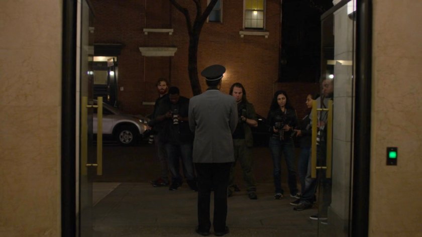 Paparazzi gather outside Trish's apartment building.