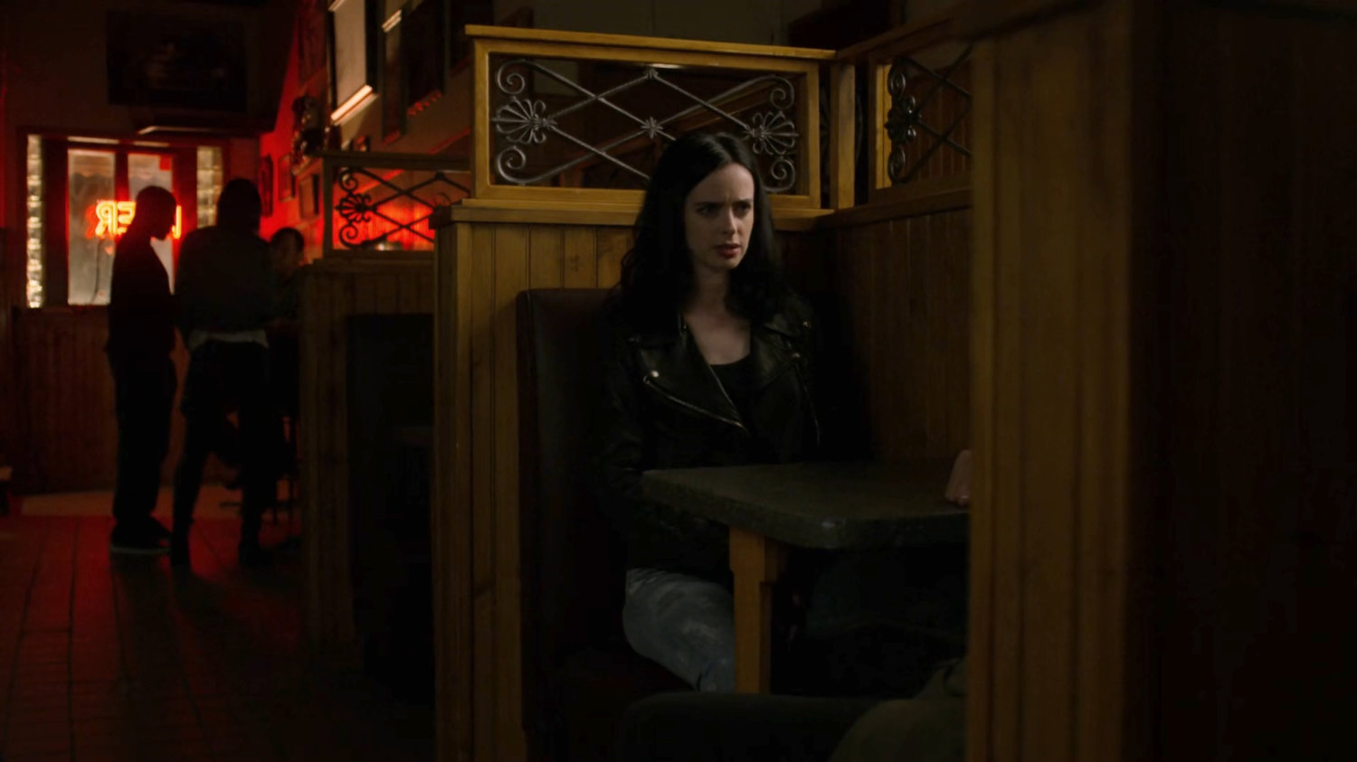 Jessica sitting in a dark bar with "Leslie Hansen" (aka Alisa).