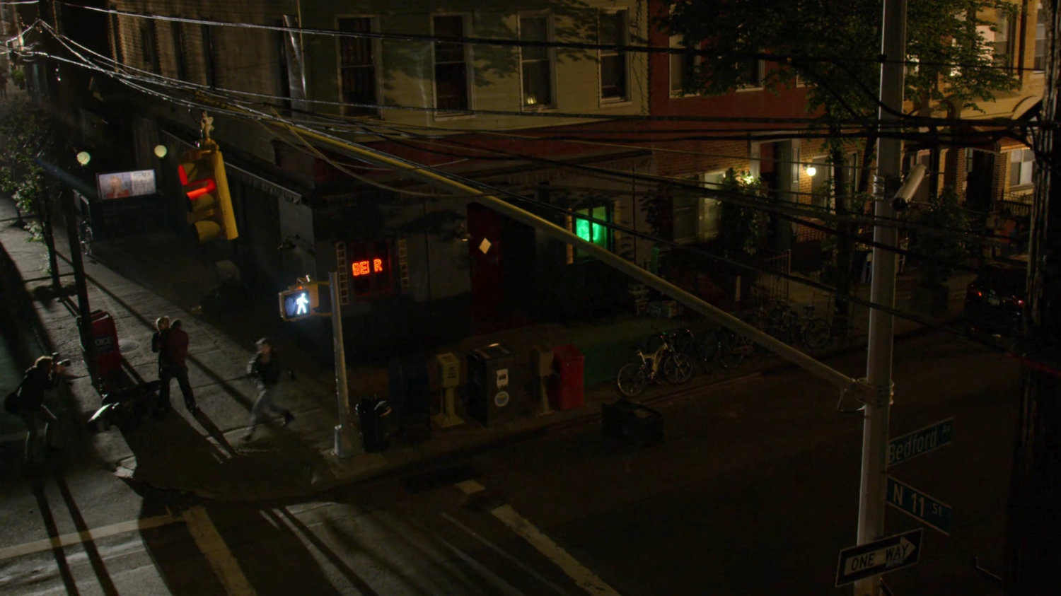 Jessica in pursuit on the sidewalk outside a dark bar.