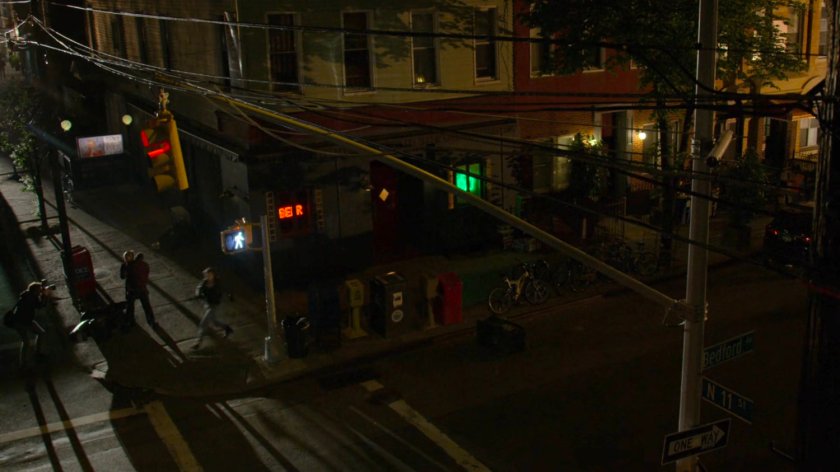 Jessica in pursuit on the sidewalk outside a dark bar.