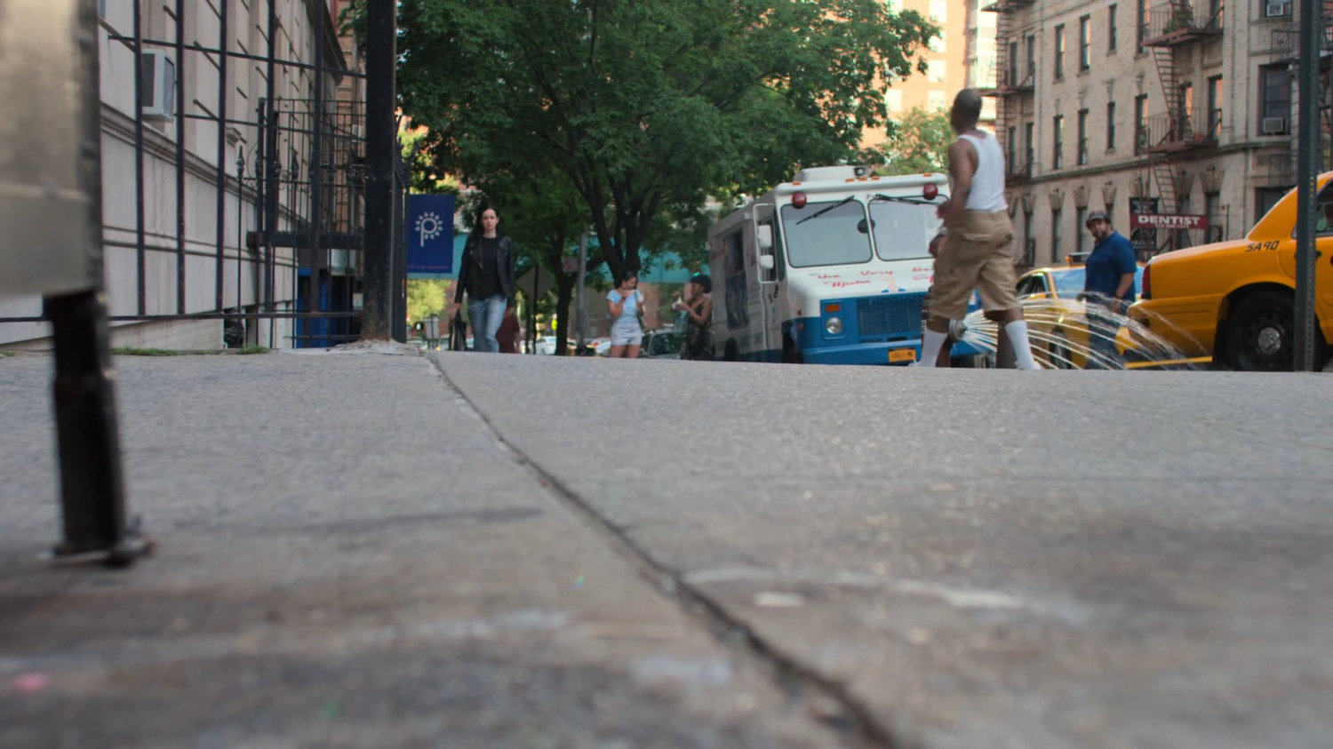 Jessica walks along the sidewalk back to her apartment building.
