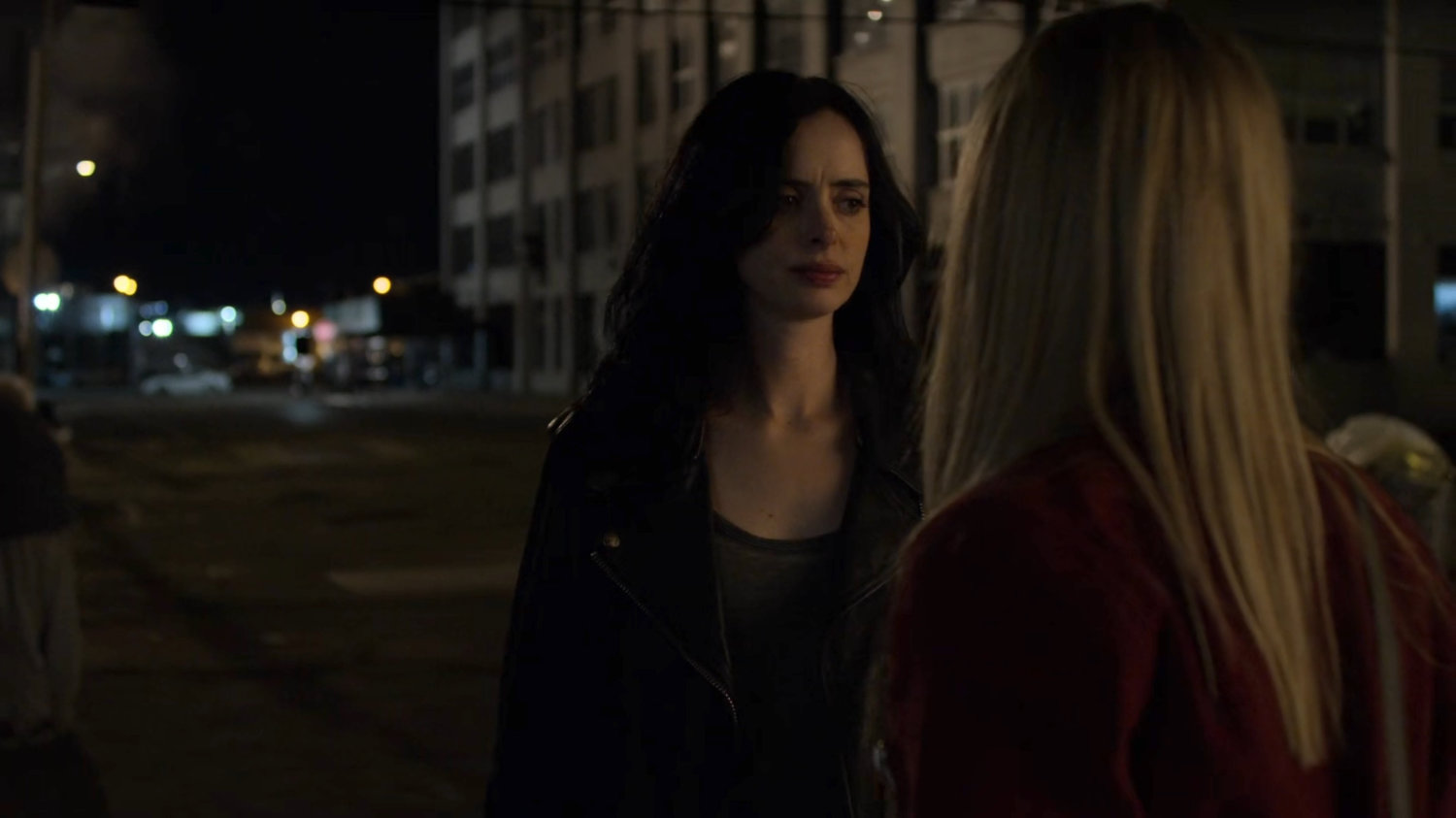 Trish and Jessica outside a homeless encampment at night.