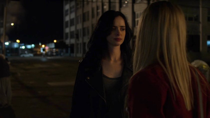 Trish and Jessica outside a homeless encampment at night.