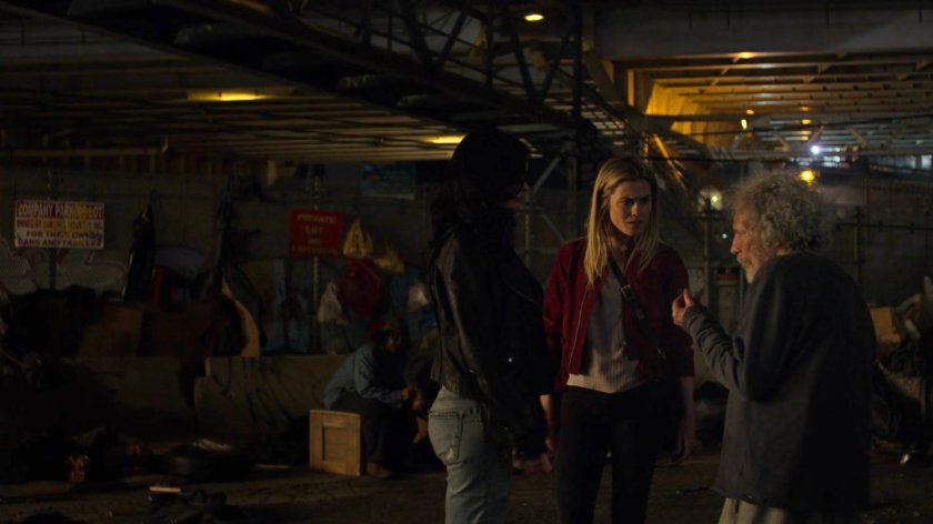 Trish and Jessica at a homeless encampment at night.