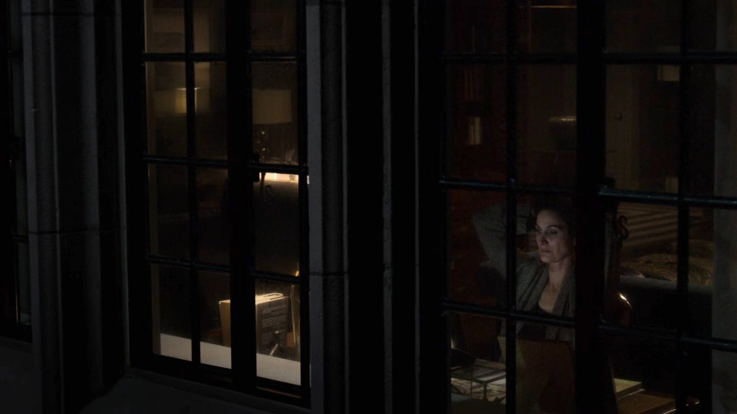 Jeri looking out the window of her apartment.