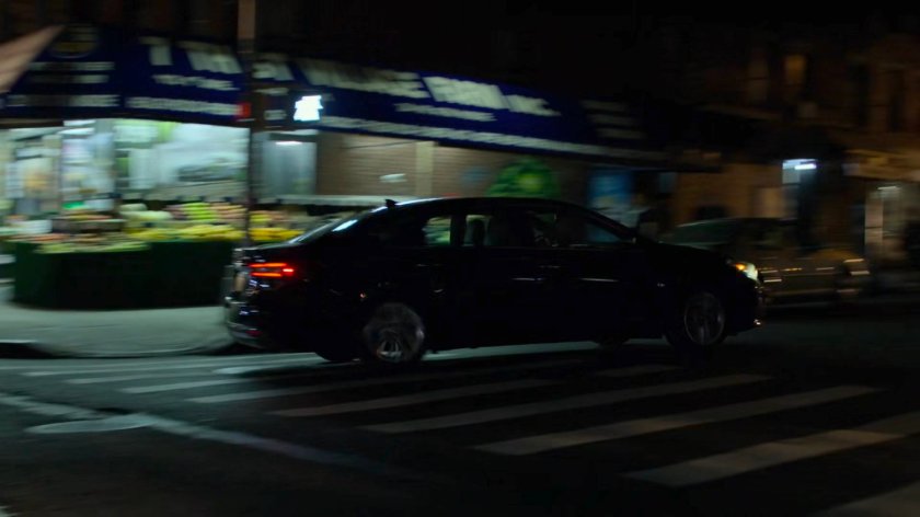 Trish's car taking a turn near Jessica's building.