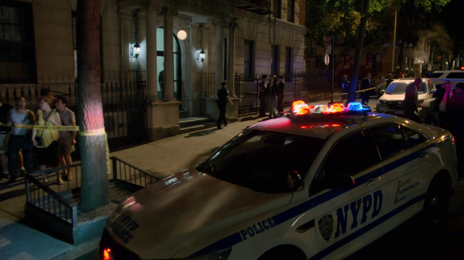 Onlookers and police gathered at a murder scene outside Jessica's building.