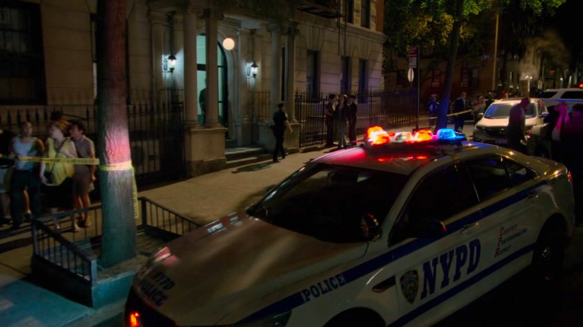 Onlookers and police gathered at a murder scene outside Jessica's building.