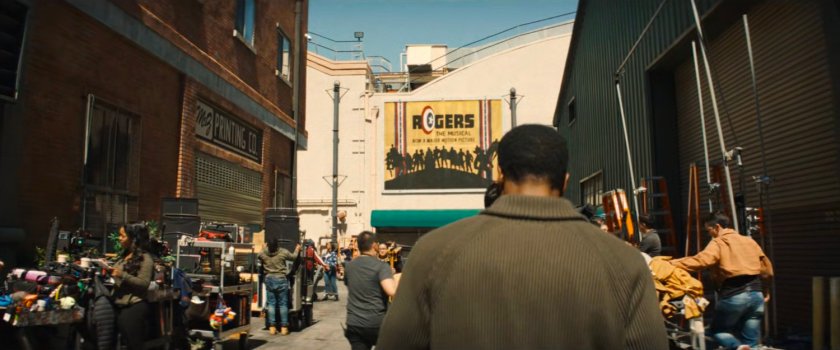 Simon Williams walking across the backlot of a Hollywood studio.