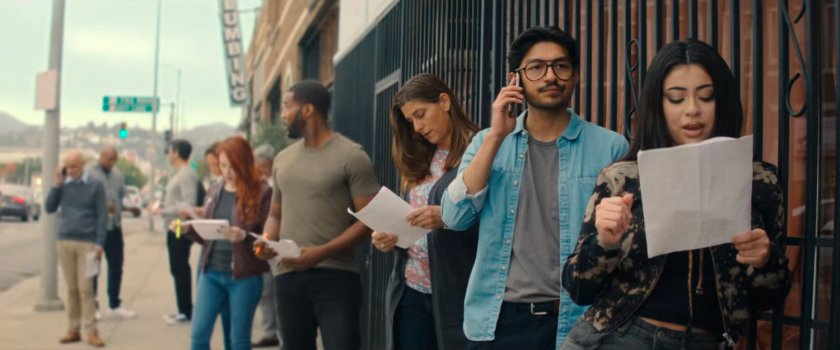 Actors in line for an audition on a sidewalk.