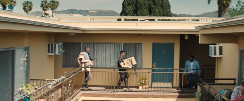 Upper balcony of Simon's apartment building with Hollywood sign in background.