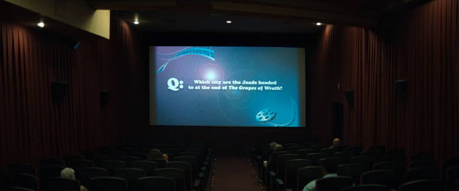 Interior of Highland Theater with trivia question on screen.