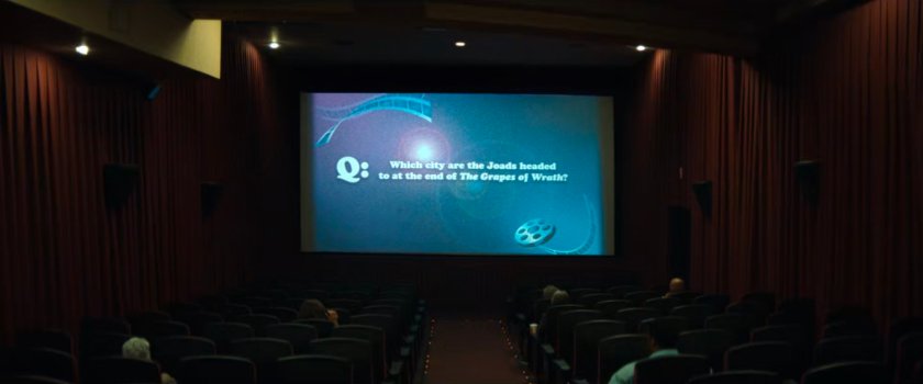 Interior of Highland Theater with trivia question on screen.