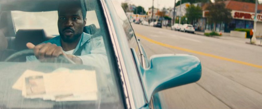 Simon driving his car on a Hollywood street.