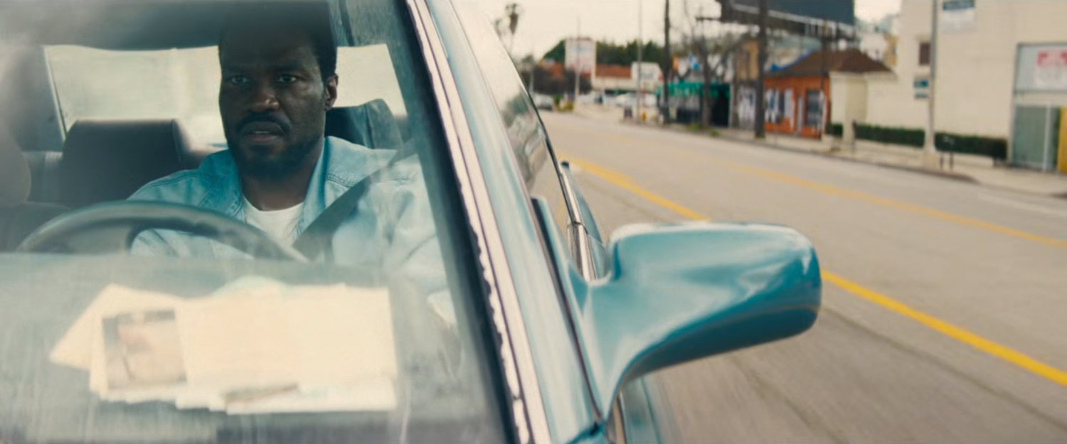 Simon driving his car on a Hollywood street.