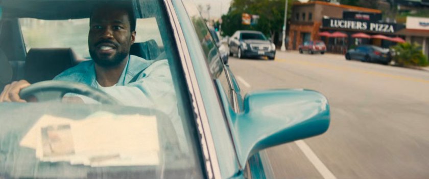 Simon driving his car on a Hollywood street.