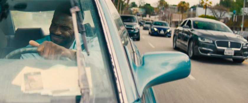 Simon driving his car on a Hollywood street.