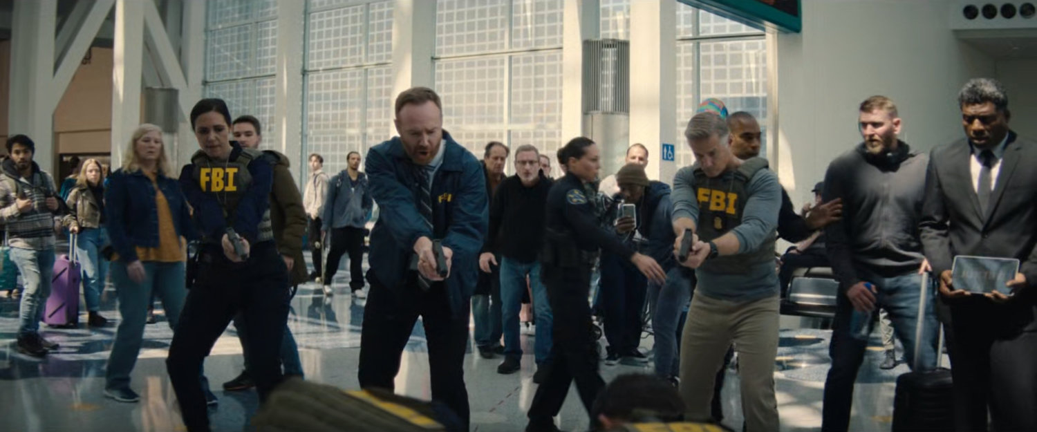 FBI Agents cover Trevor in the Los Angeles Airport terminal.