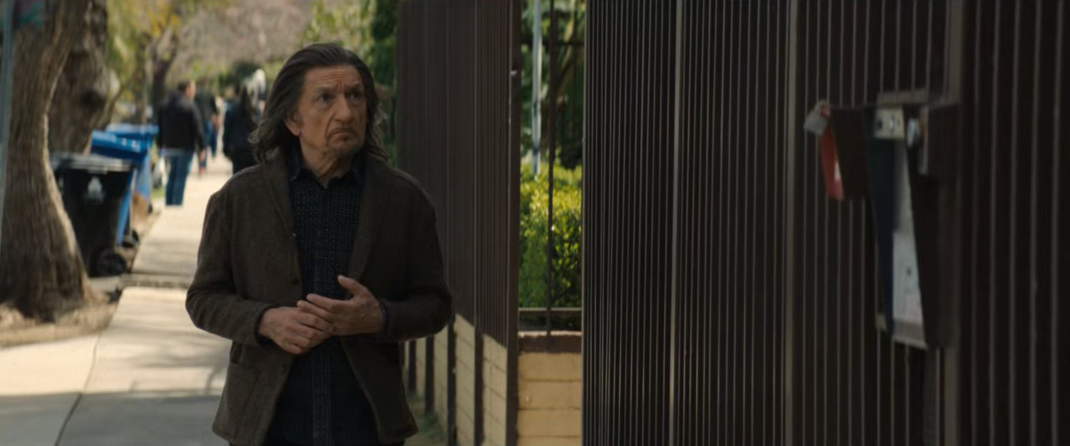 Trevor outside Simon's apartment building.