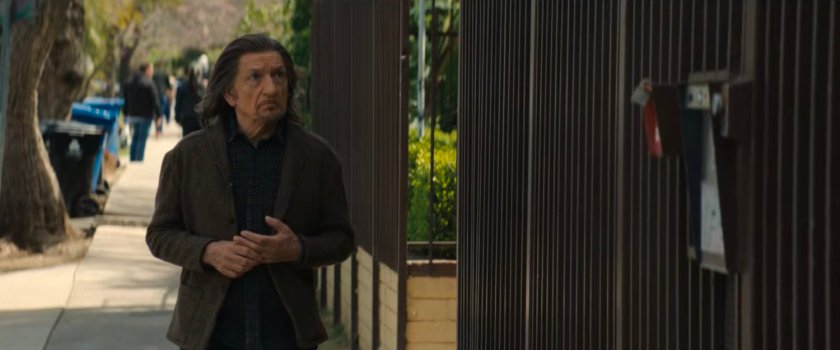 Trevor outside Simon's apartment building.