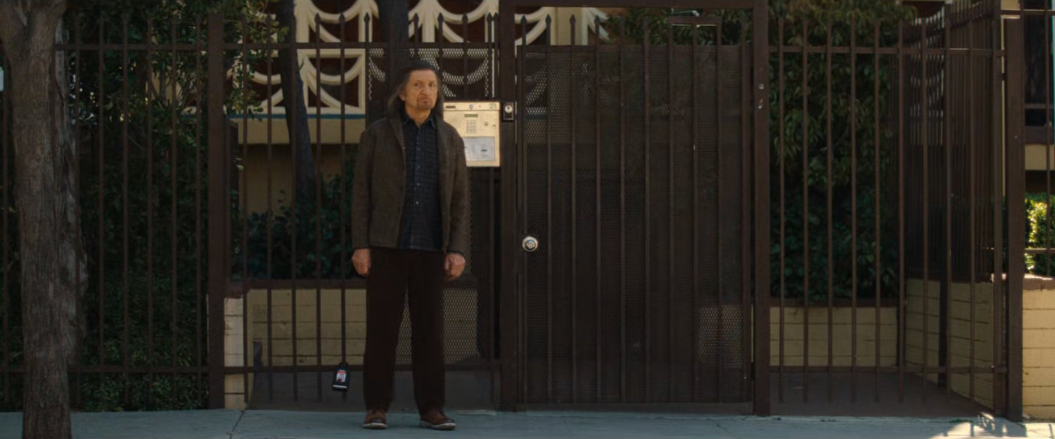 Trevor outside Simon's apartment building.