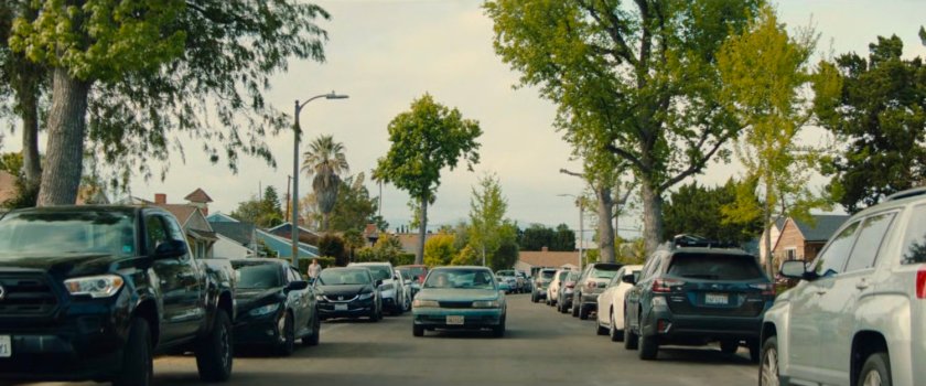 Simon's car driving along a crowded Pacoima street.