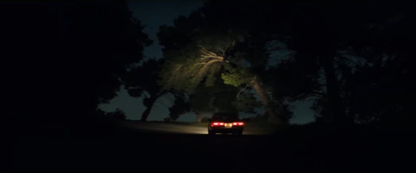 Simon's car on a dark hilly road.