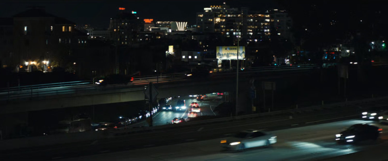 Nighttime view of Hollywood freeway and streets.