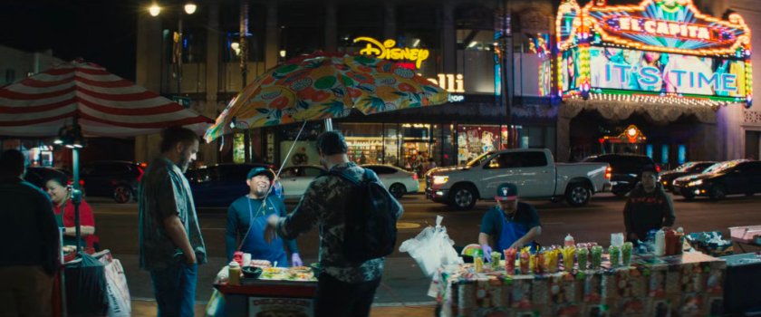 Nighttime view of vendors on sidewalk in front of El Capitan Theater.