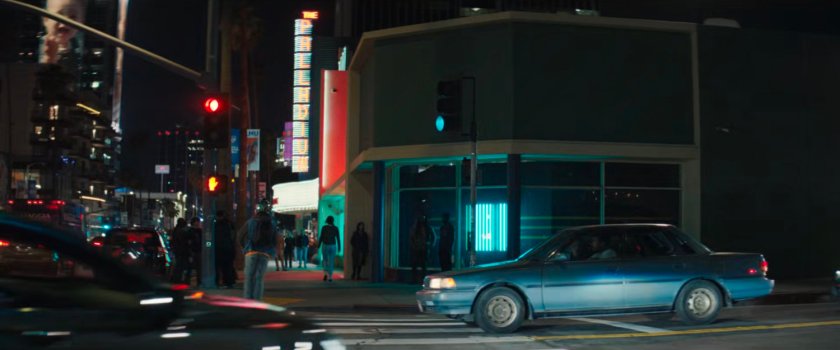 Simon's car stopping for Jayden as he crosses the crosswalk on his scooter.