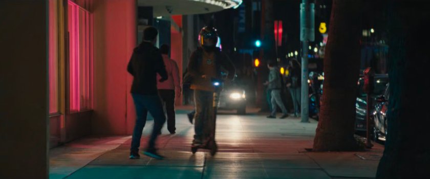 Jayden zipping along the sidewalk on his scooter outside the Palladium.