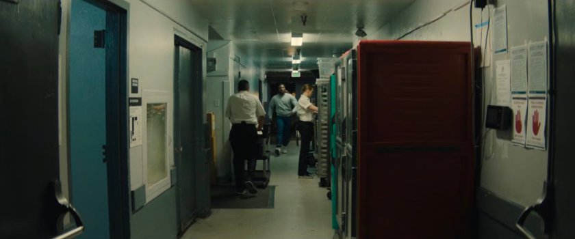 Simon walking through a back hallway of a club.