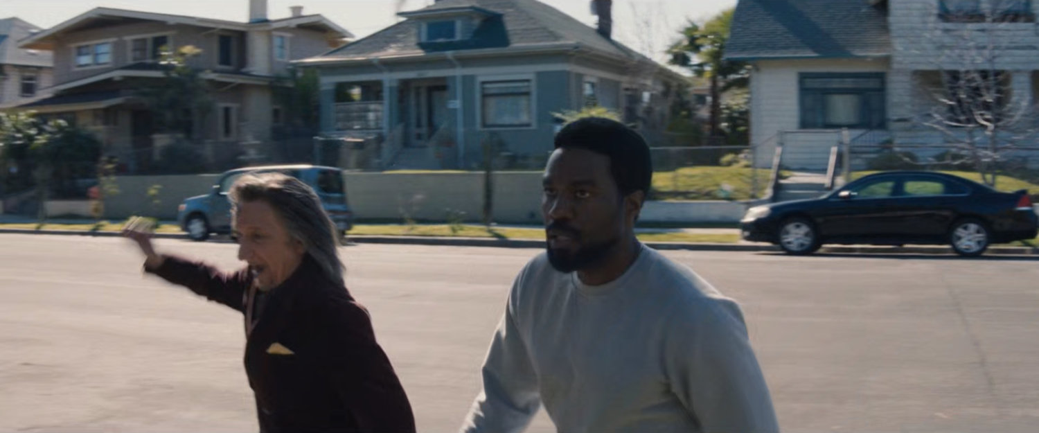 Trevor and Simon cross the street towards Esteban's house.