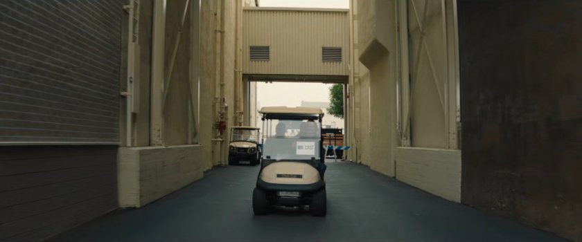 Golf cart in a small backlot alley of a Hollywood studio.