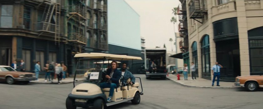 Golf cart on a backlot street of a Hollywood studio.