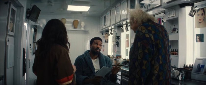 Simon speaking with Von Kovak in the makeup trailer.