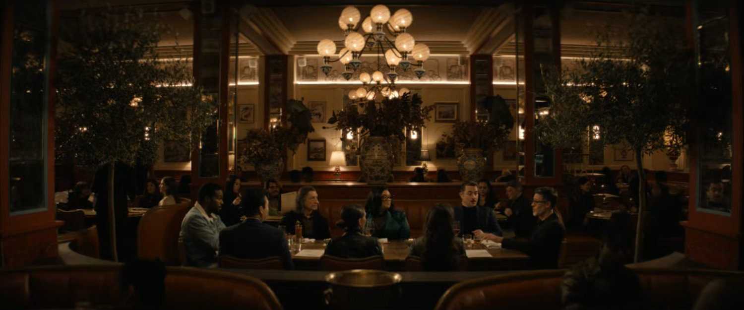 Janelle and her team with Simon and Trevor at a table in a restaurant.