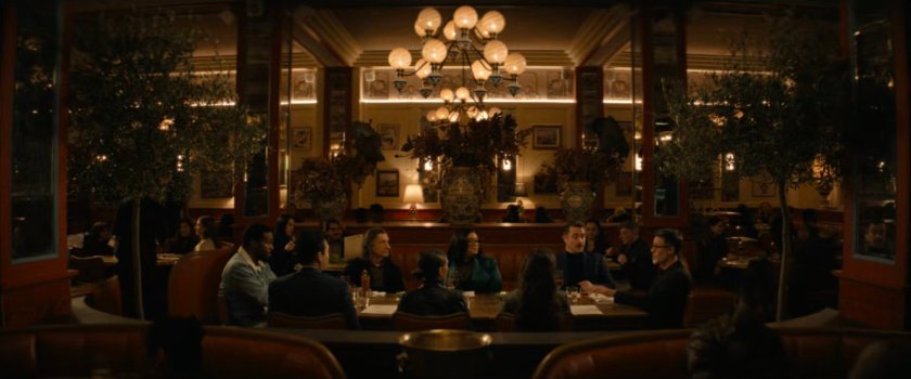 Janelle and her team with Simon and Trevor at a table in a restaurant.